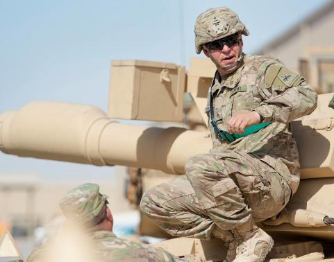 U.S. Army Sgt. Jordan Gassie, a mechanic assigned to 1st Battalion, 37th Armor Regiment, 2nd ABCT, 1st Armored Division inspects an M1A2 Abrams Main Battle Tank during an issue exercise for combat configured Army Prepositioned Stocks-5 equipment led by the Army Field Support Battalion-Kuwait, 401st Army Field Support Brigade at Camp Arifjan, Kuwait, Jan. 27. U.S. Army Photo by Justin Graff.