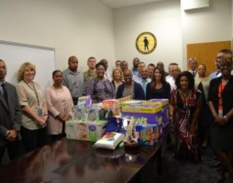 AHRS team standing around table with supplies that were collected.