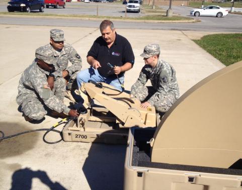 DWTS contractor Mikey Gerogianis preparing CSS-VSATs for deployment to Africa.