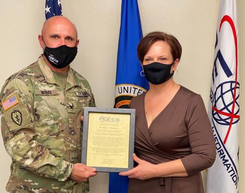 COL Rob Wolfe presents EBS-C charter to Ms. Jeannie-Winchester