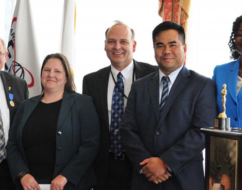 Dr. Dave Powers (left) stands with members of the Force Management System team during his retirement ceremony held at Fort Belvoir.