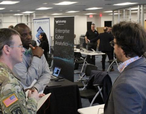 Lt. Col. Scott Helmore, Product Manager Cyber Platforms and Systems, and Eric Barry, CPS IT Specialist, meet with a Forge Storm vendor.