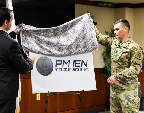 PEO EIS leaders unveil new PM IEN logo.