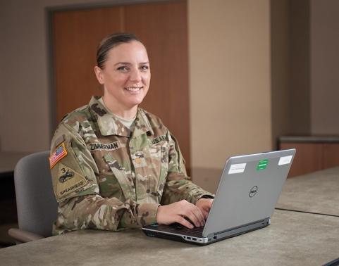 IPPS-A Soldier working at a laptop solo