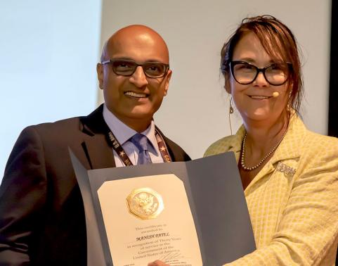 Photo of Mr. Patel and Ms. Smith celebrating 30-years-of-service certificate