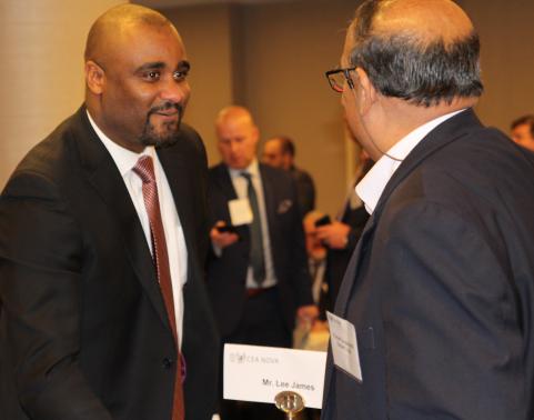 Mr. Lee James, III shakes hands with an industry representative at the 2020 AFCEA NOVA Army IT Day event.