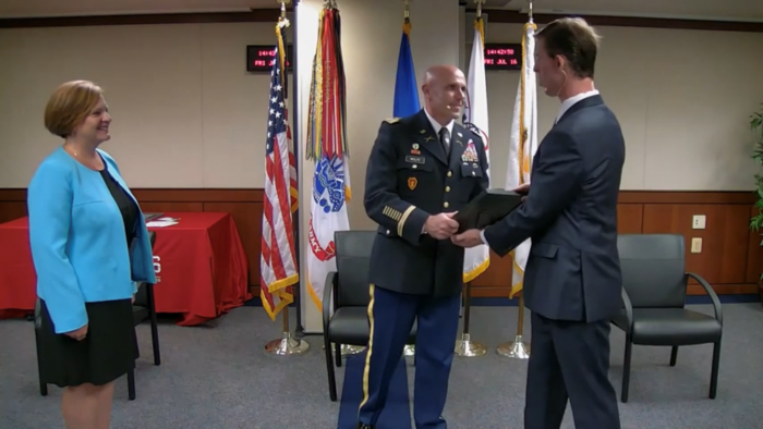 COL Rob Wolfe (center) presents the EBS-C charter to Preston Hayward (right) from Jeannie Winchester (left) during a ceremony on July 16, 2021.