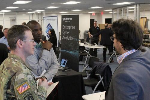 Lt. Col. Scott Helmore, Product Manager Cyber Platforms and Systems, and Eric Barry, CPS IT Specialist, meet with a Forge Storm vendor.