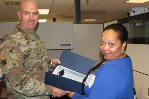 Col. Harris presents civilian employee with certificates of appreciation