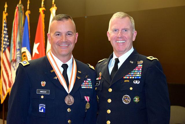 Two soldiers smile for photo.