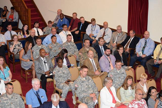 Photo of crowd sitting in auditorium. 