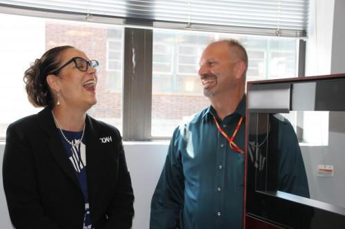 Ms. Cherie Smith, PEO EIS, shares a laugh over Army vs. Marines with Marine Corps veteran Mr. John Galvin.