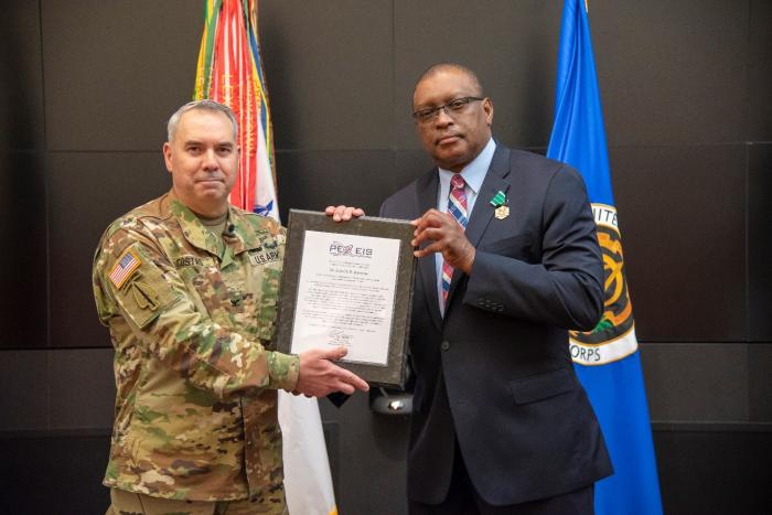 Col. Enrique Costas accepts the charter for Land Mobile Radio from outgoing product lead, Patrick Barnette.