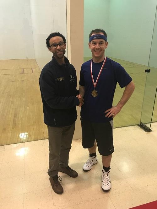Two men standing in racquetball court